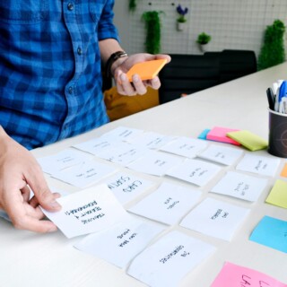 Image of a man card sorting with sticky notes.